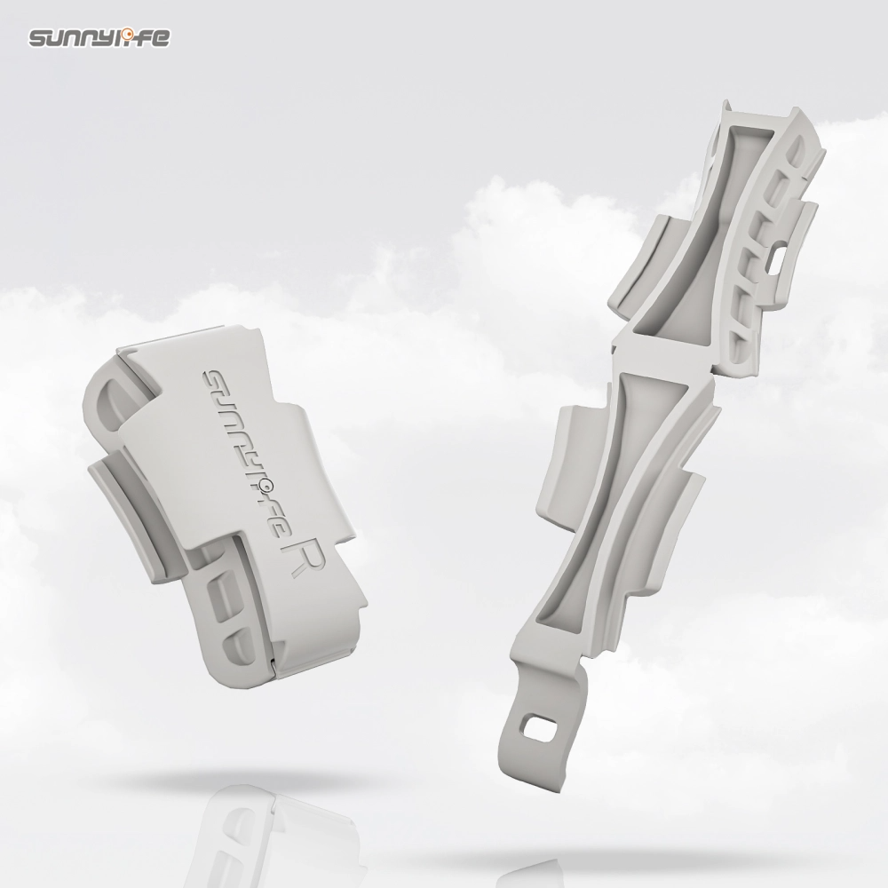 Two light gray bicycle chain guard covers by Sunnyife floating against a soft white cloud-like background. One cover is shown from the front with the Sunnyife logo, and the other shows the side profile with cutouts.